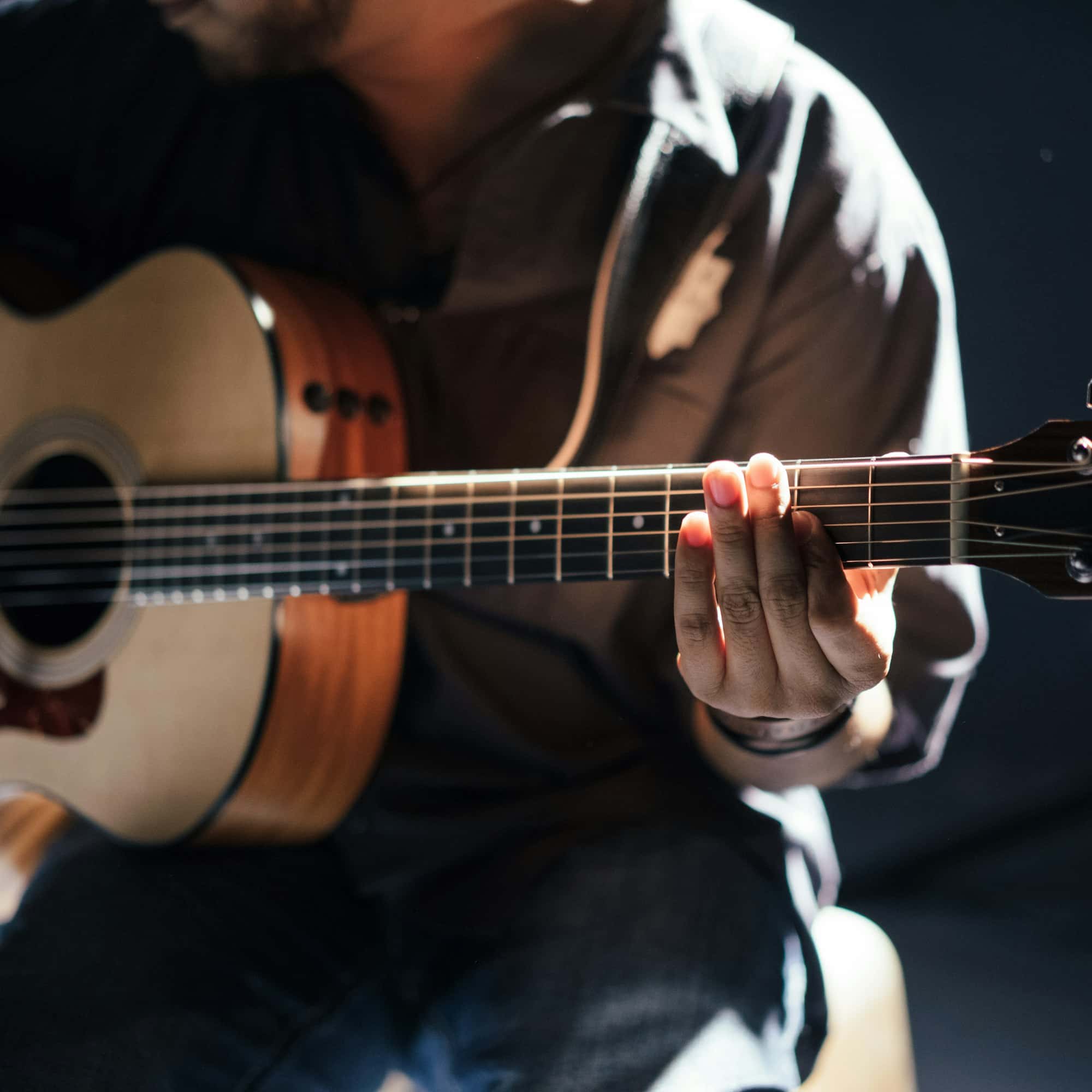 A musician playing acoustic guitar