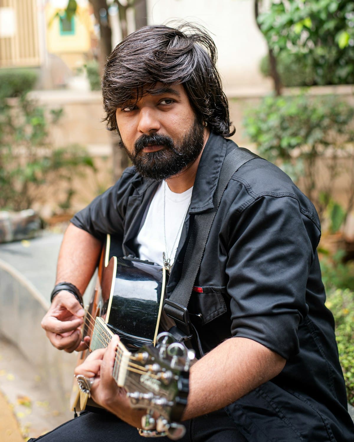 Portrait of a guitarist holding an acoustic guitar