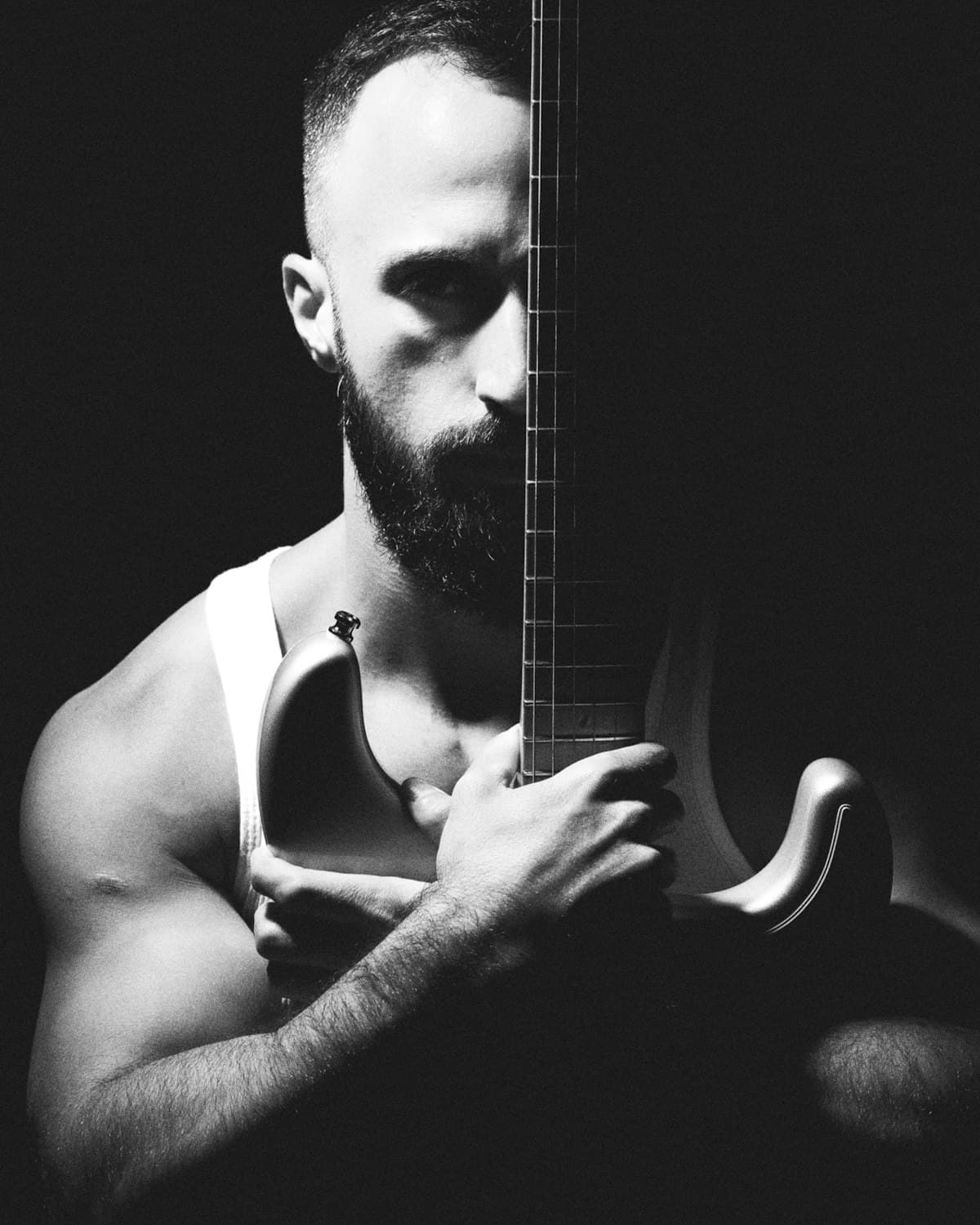 Black and white portrait of a musician holding a guitar