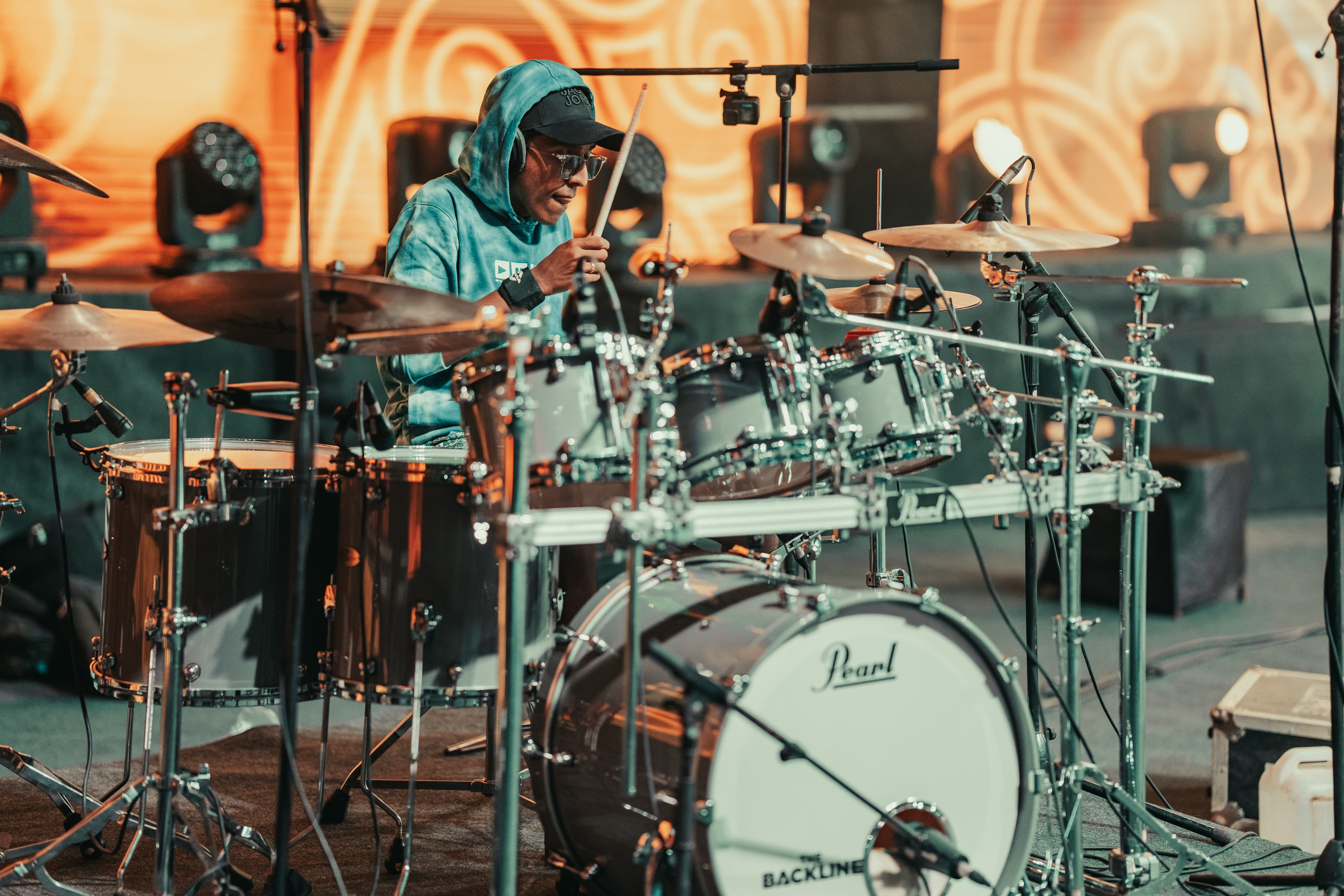 Close-up of hands playing the tabla on stage